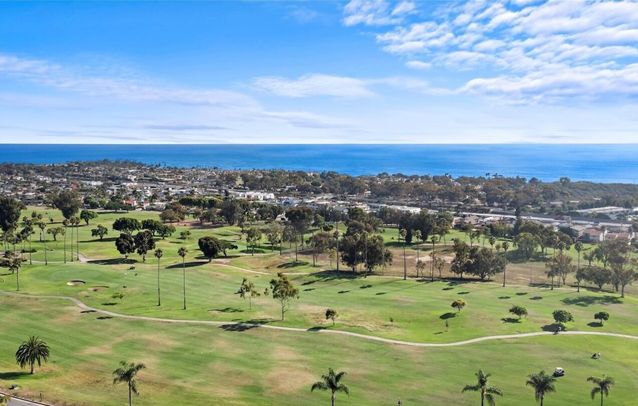 Aerial view of a San Clemente golf course with the Pacific Ocean beyond