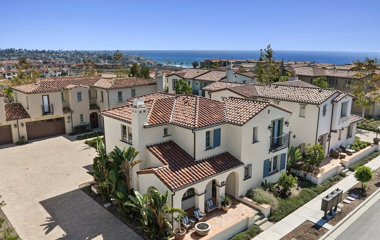 Spanish-style homes with red tile roofs in Sea Summit, San Clemente, with the Pacific Ocean on the horizon