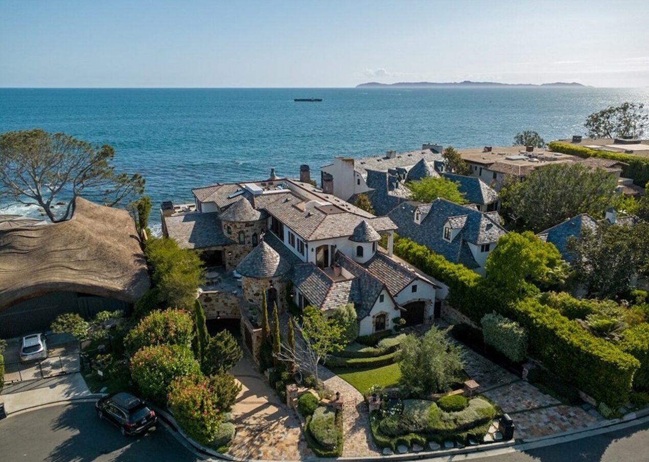 Aerial view of an ocean-view home and neighboring rooftops above the Pacific in Shorecliffs, San Clemente