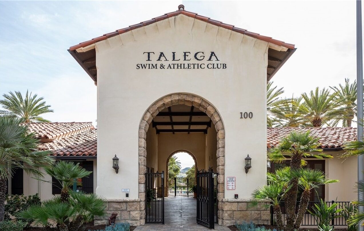 Entrance to the Talega Swim & Athletic Club with a stone archway and tile roof