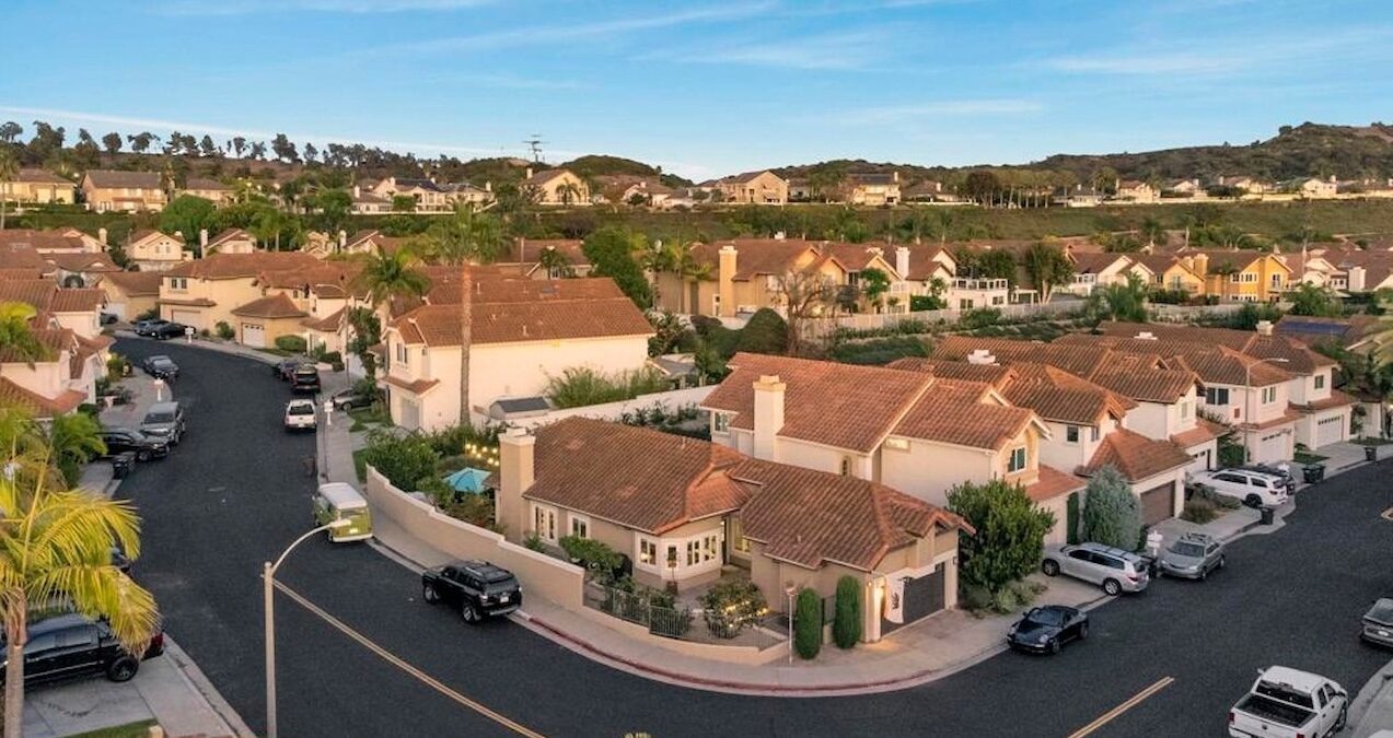 Tile-roof homes on a quiet San Clemente street at golden hour